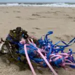 Balloon and ribbon washed up on beach