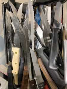 Bin of knives in a thrift store